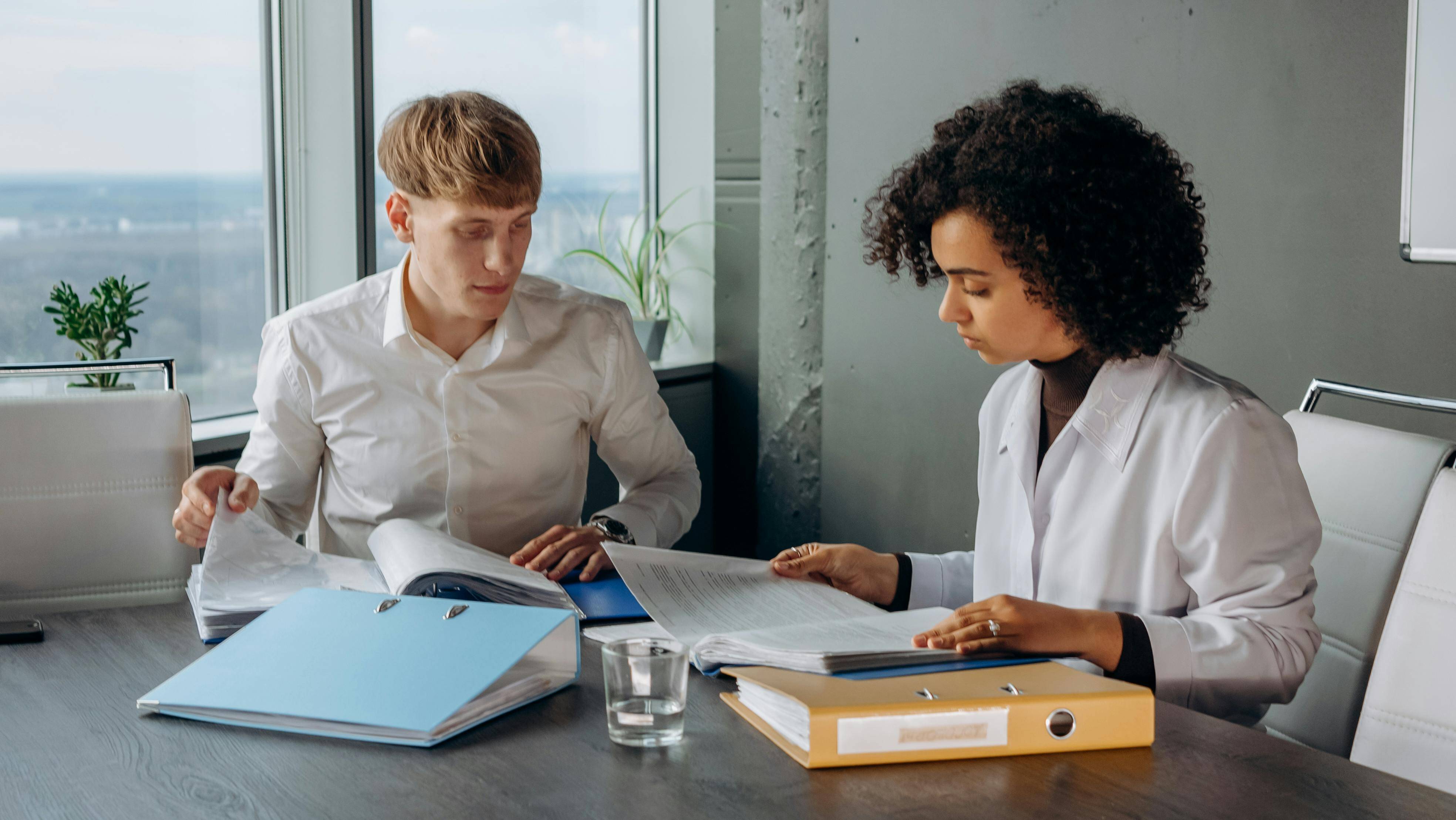 two coworkers review paperwork