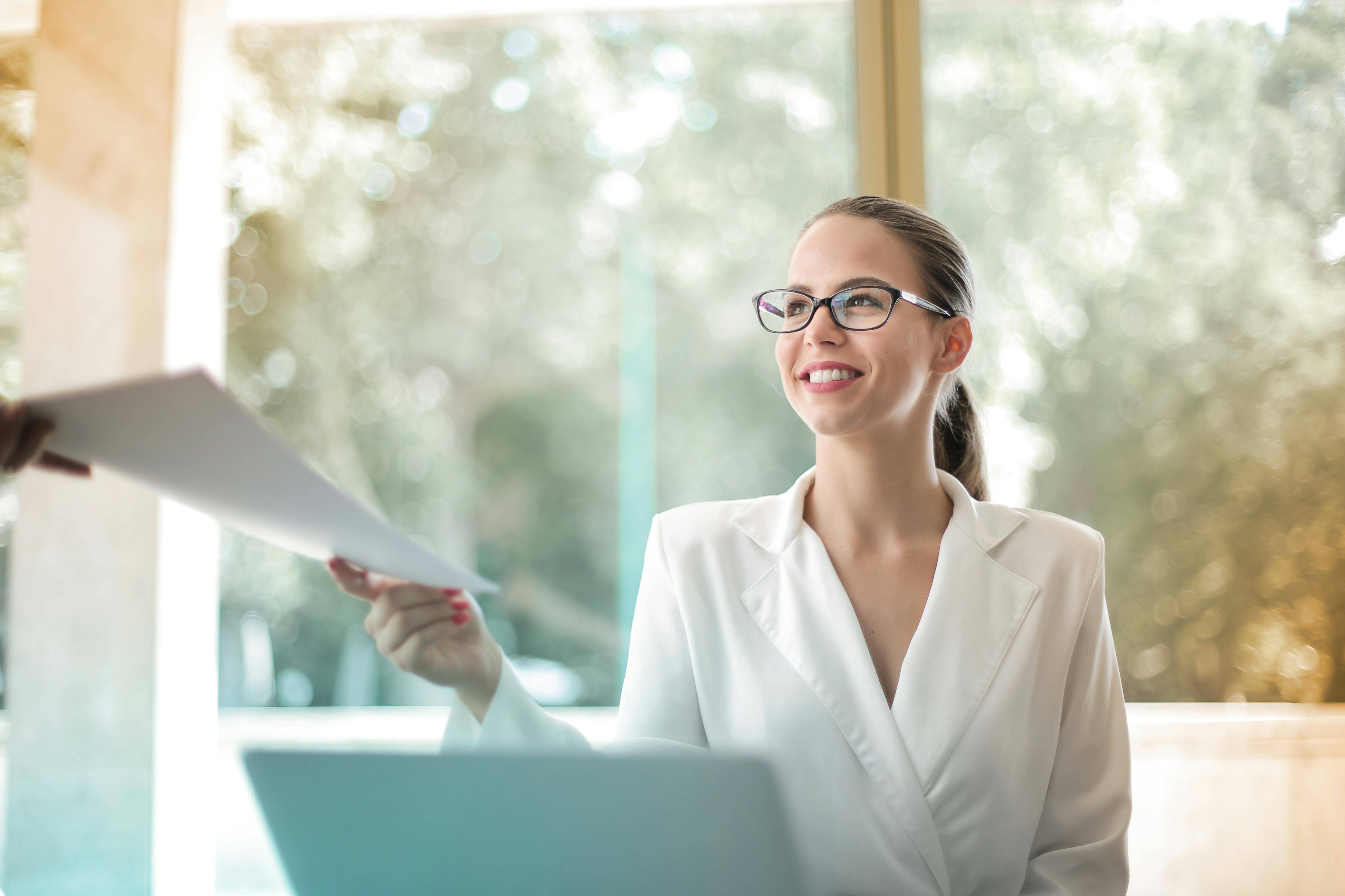 woman receives stack of invoices to process