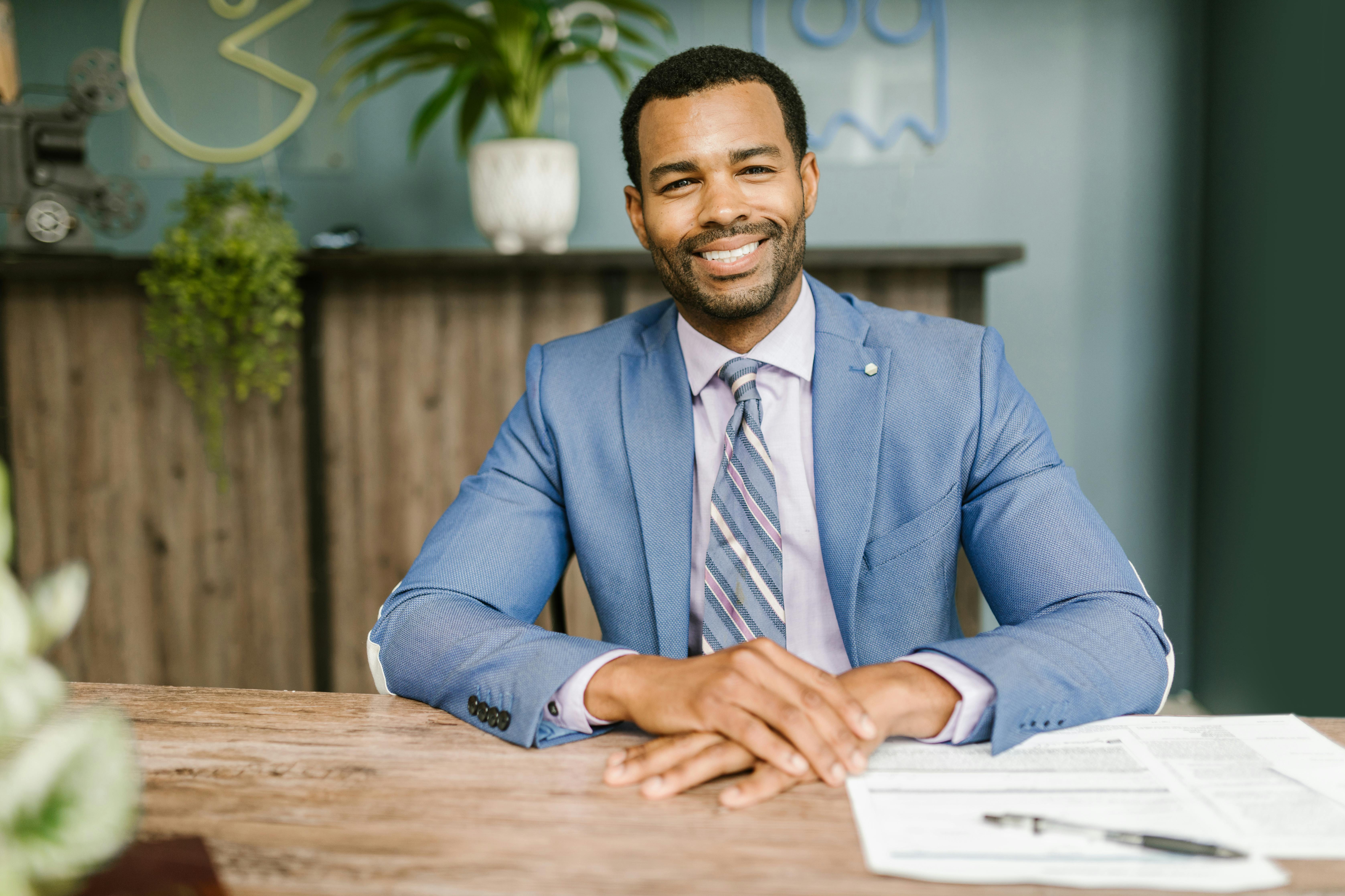 professional man smiles while working at desk